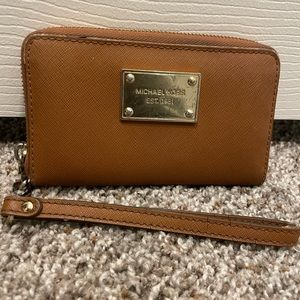 Michael Kors tan wristlet.